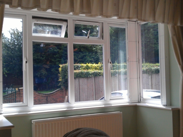 Bay window security grilles drawn back neatly