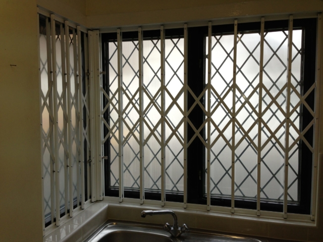 Sliding safety grilles in kitchen