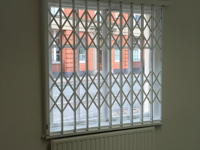 Collapsible security grilles on office windows
