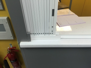 Lift out track grille for reception desk Lift out track grille