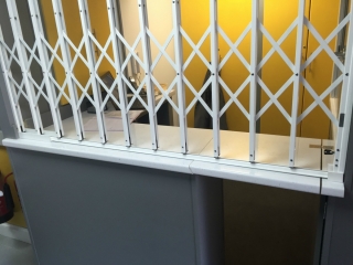 Security grille for reception desk using Lift-Out Track Security grille for reception desk using Lift-Out Track