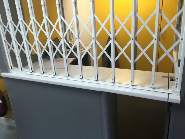 Security grille for reception desk using Lift-Out Track