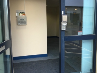 Commercial security door grilles drawn back using lift out track Commercial security door grilles drawn back using lift out track