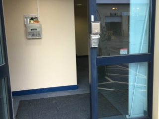 Commercial security door grilles drawn back using lift out track removed Commercial security door grilles drawn back using lift out track removed